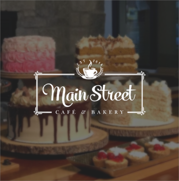 the Main Street Cafe & Bakery logo laid overtop a picture of cake and other sweets